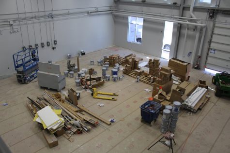 Various tools and materials are spread across the floor of one room in the experimental engineering building on the new Innovation Campus.