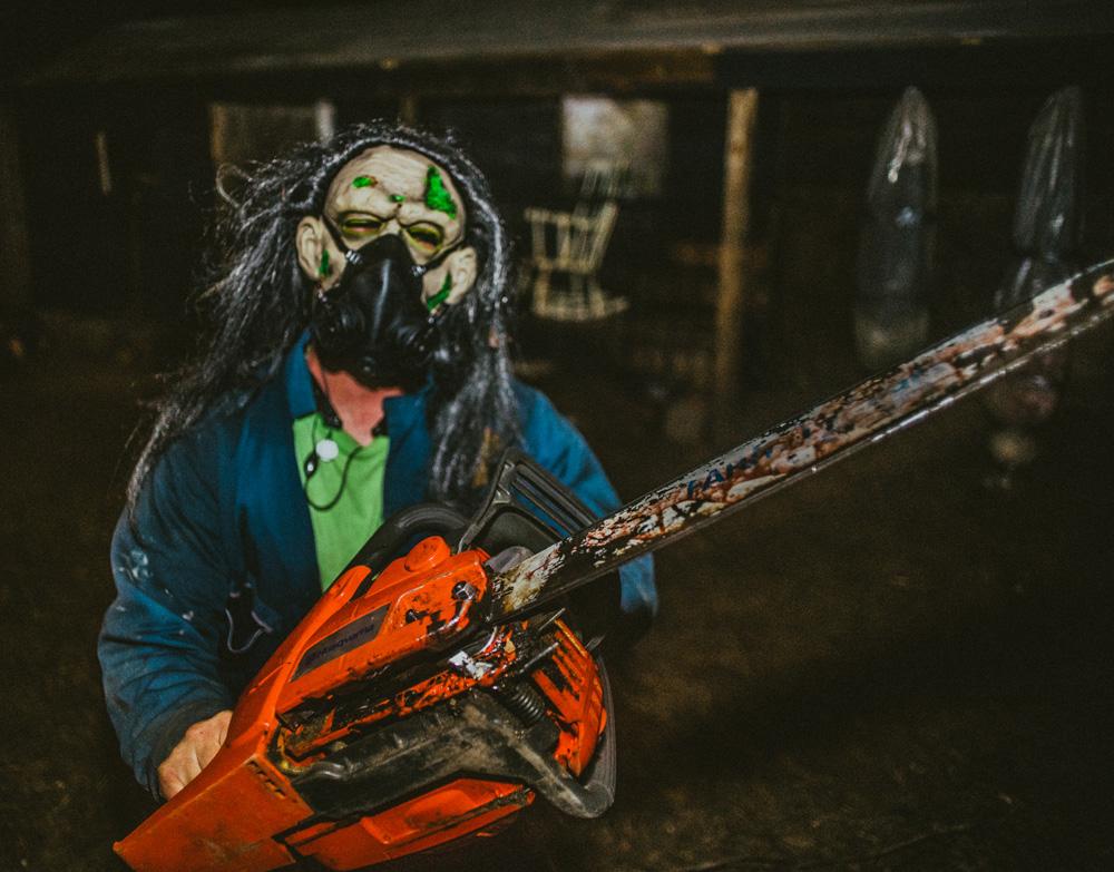 An actor with a chainsaw poses for a picture at the Wicked Island at OJ Watson Park. The Wicked Island is located at 3022 S. Mclean Blvd.