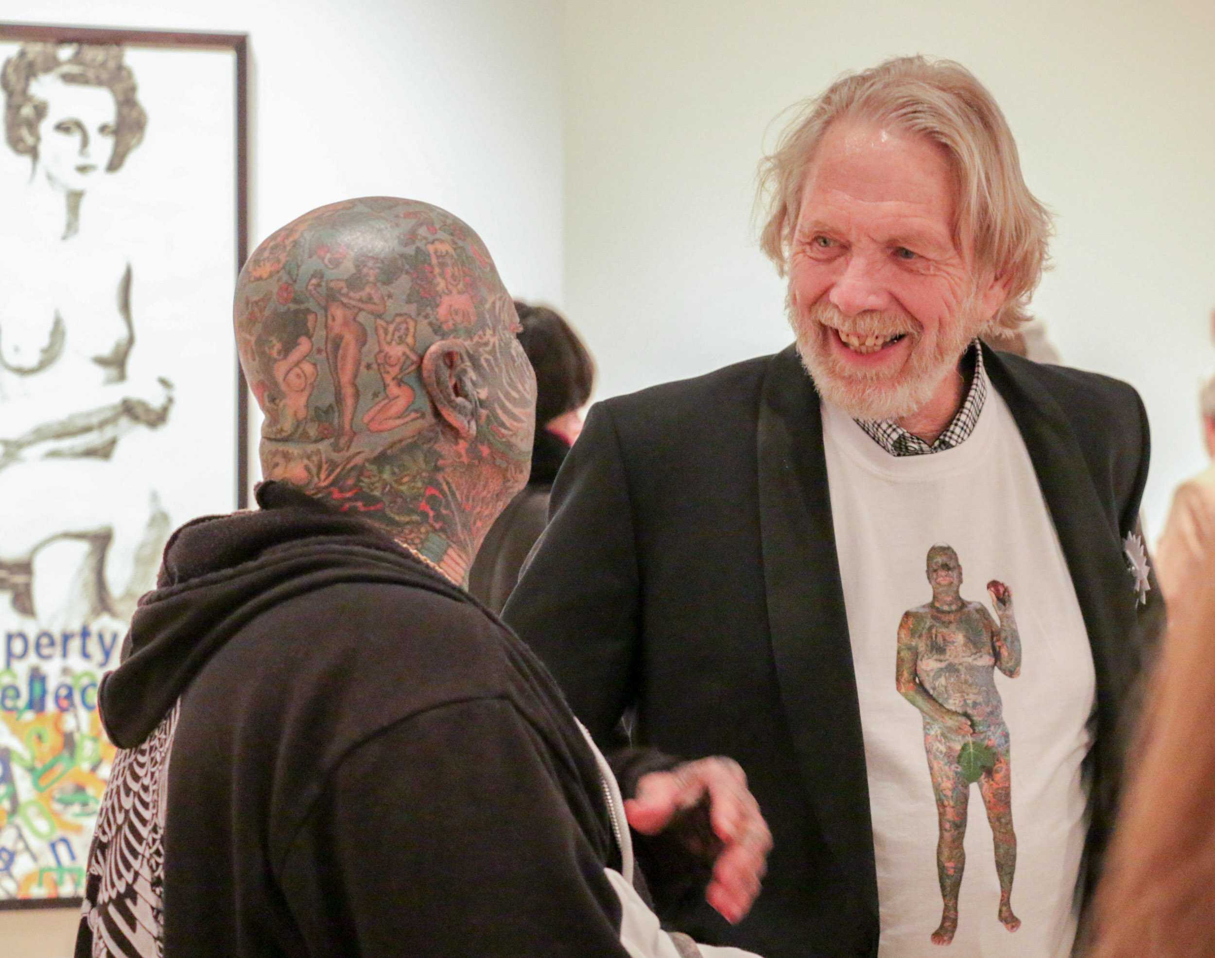 Professor Larry Schwarm talks to his subject Larry K. during opening night at the Ulrich Museum of Art on Saturday.