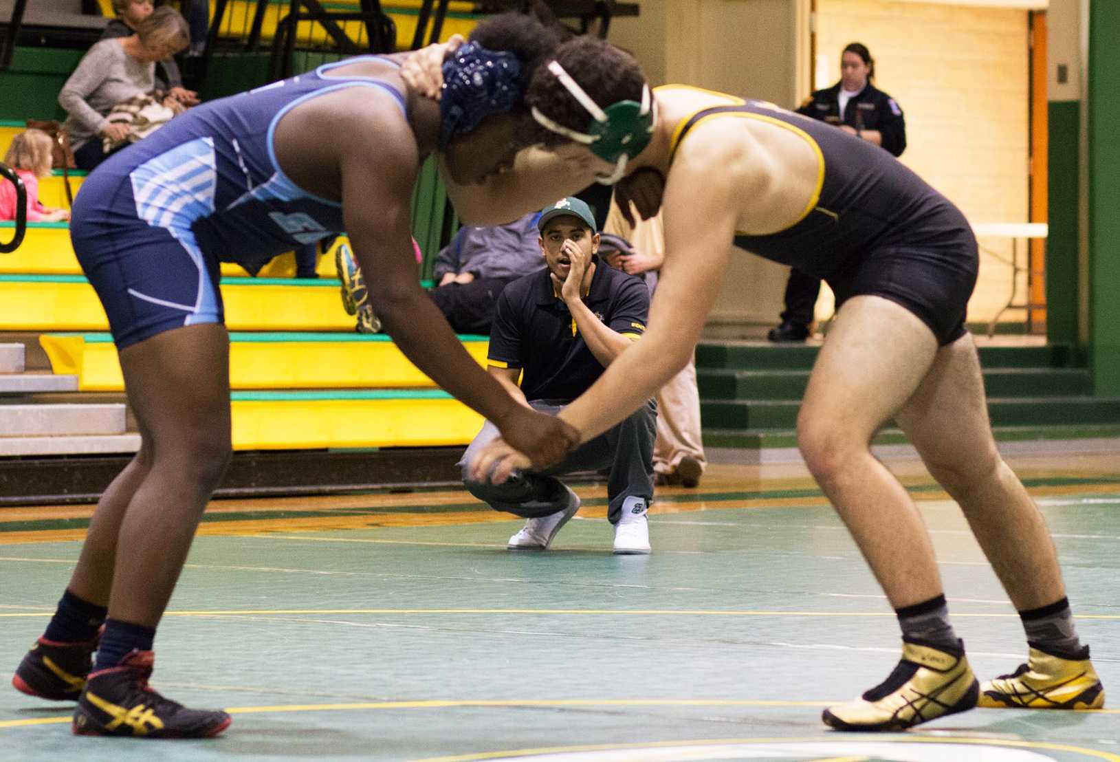 Dominic Davis, a freshman majoring in biology at Wichita State, coaches a wrestler from the side of the mat at Bishop Carrol High School. (Feb. 1, 2017)