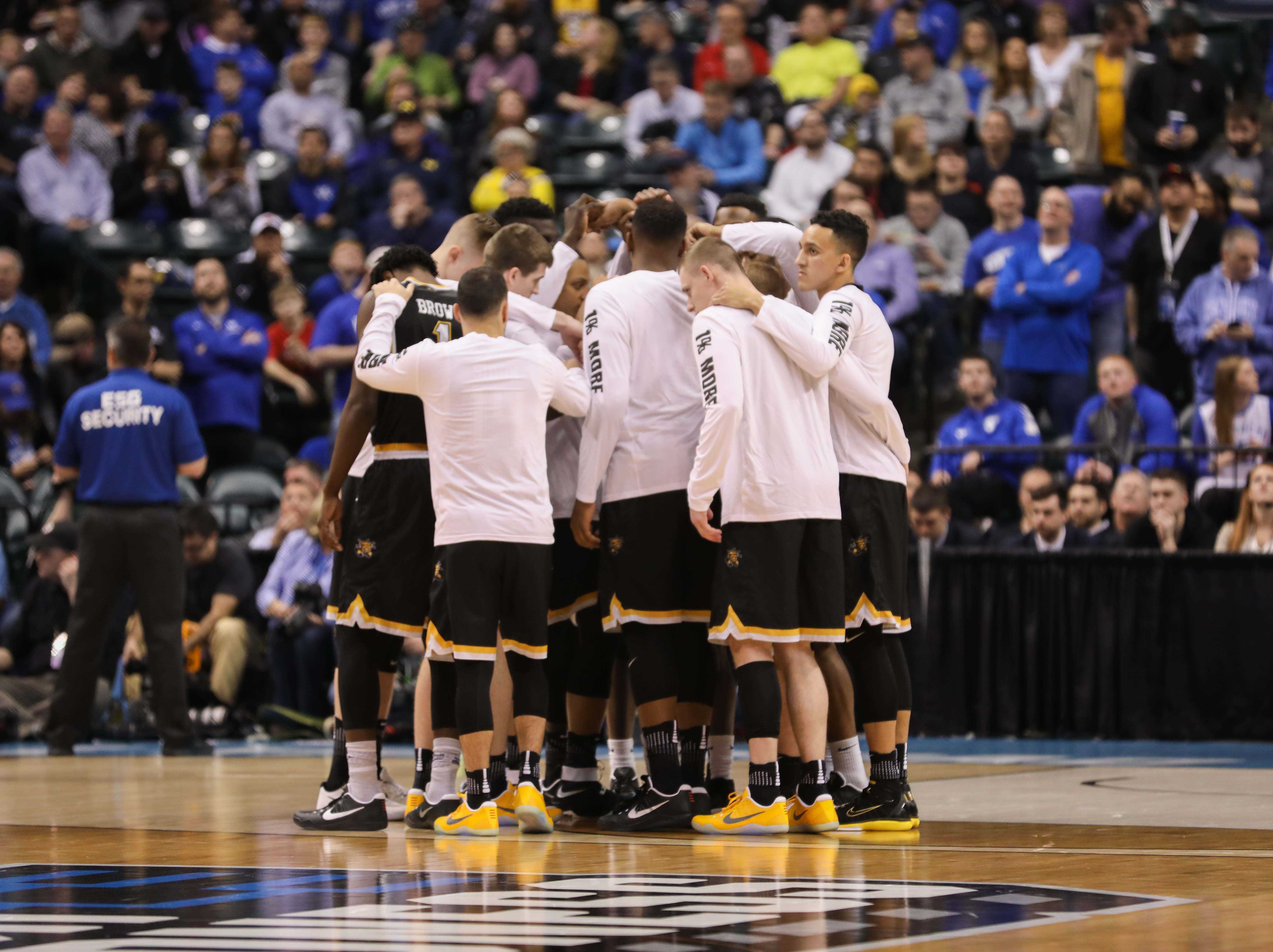 Wichita State huddles on the court right before tipoff of the game against the Kentucky Wildcats in the second round of the NCAA Tournament in Indianapolis. (Mar. 19, 2017)