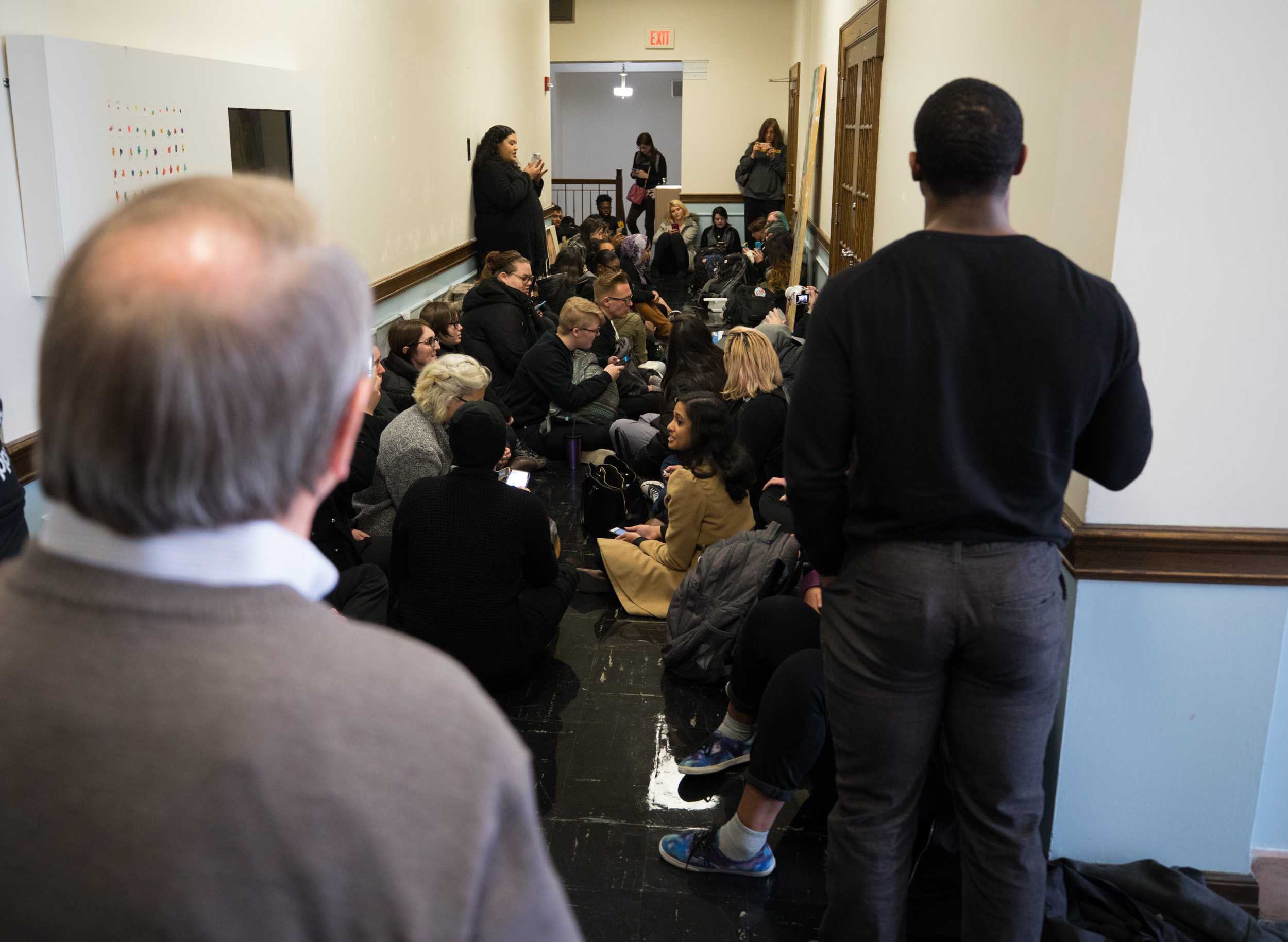 Lou Heldman, vice president of strategic communications, foreground, looks at a group of student protesting outside go John Bardo’s office.
The group were demanding transparency and to know what happened to Eric Maki. (Mar. 14, 2017)