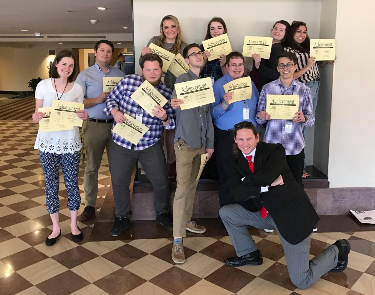 Members of The Sunflower staff pose with certificates earned at the Kansas Collegiate Media conference, held last month in Wichita. The staff collected 42 awards at
the conference.