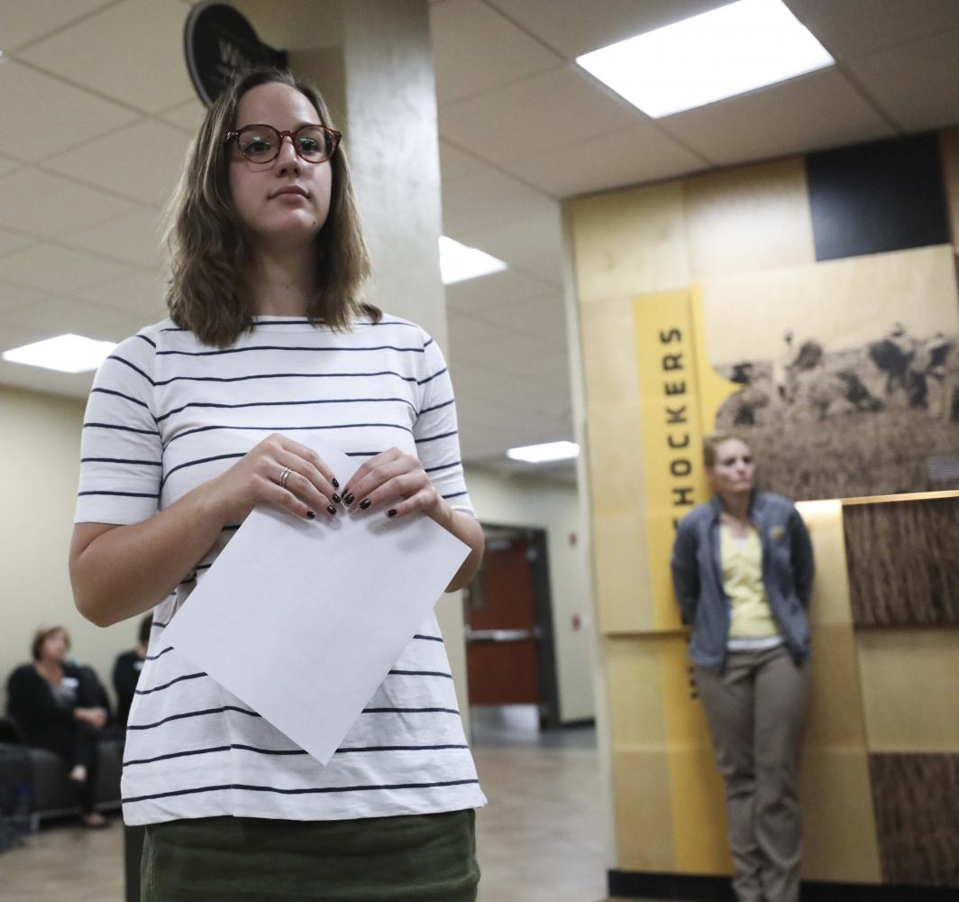Student Body President Paige Hungate responds to a list of demands presented to her outside the Student Government Association offices.