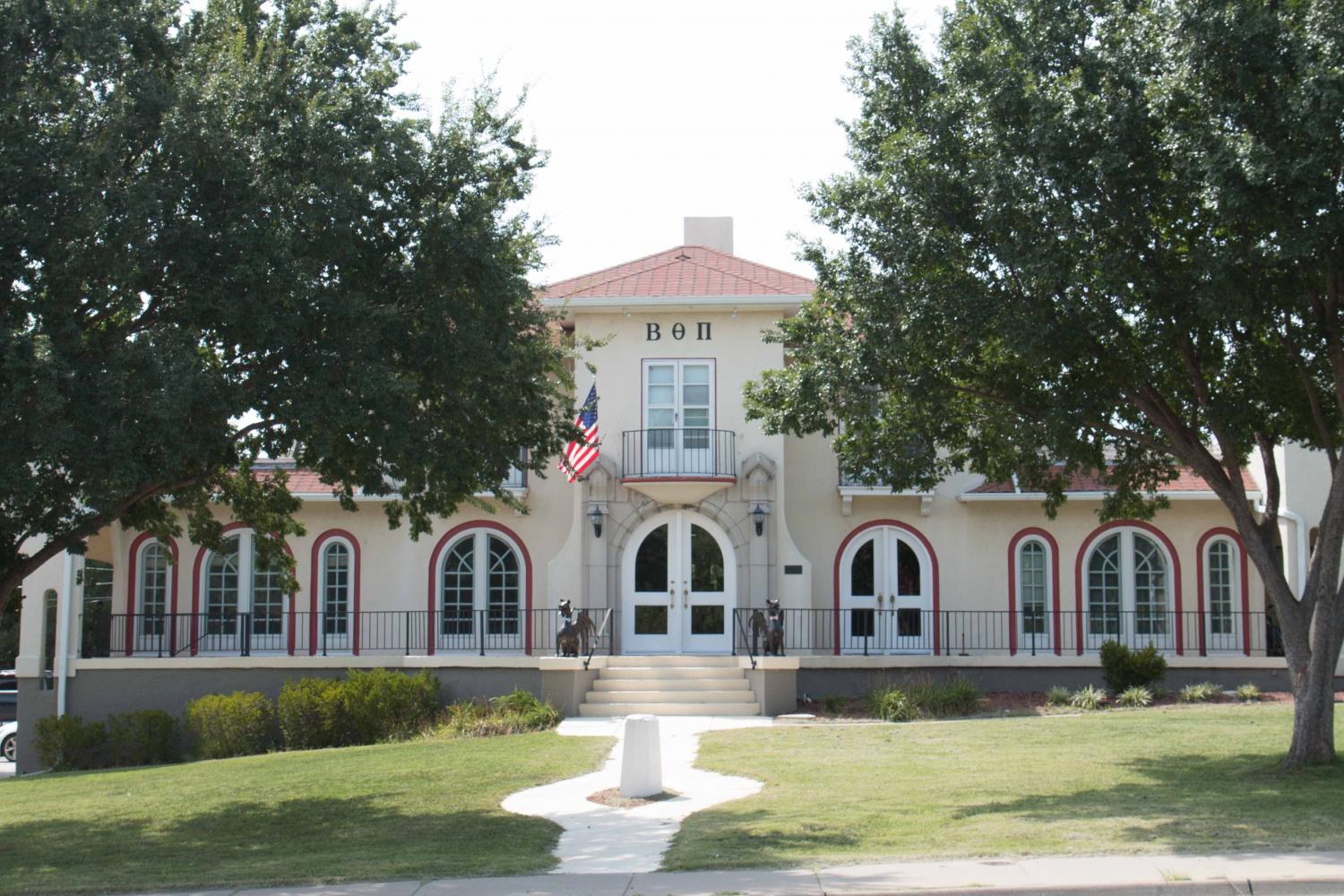 the beta theta pi fraternity house sits on hillside across