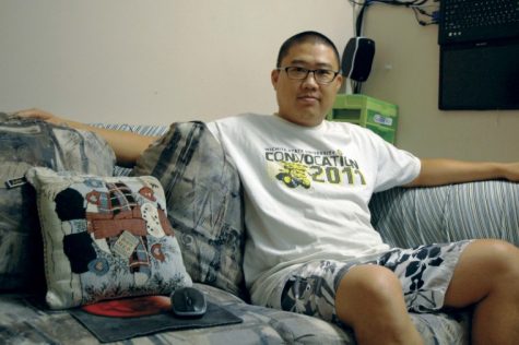 Long Wang, senior, President of the Chinese Student and Scholar Association. Relaxes on his personal couch at Wheatshocker.

