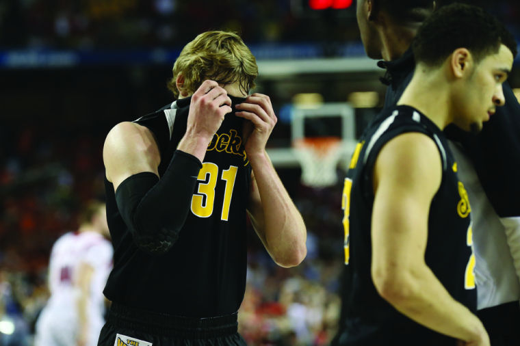 Ron Baker covers his eyes after the conclusion of Saturdays game against Louisville.

