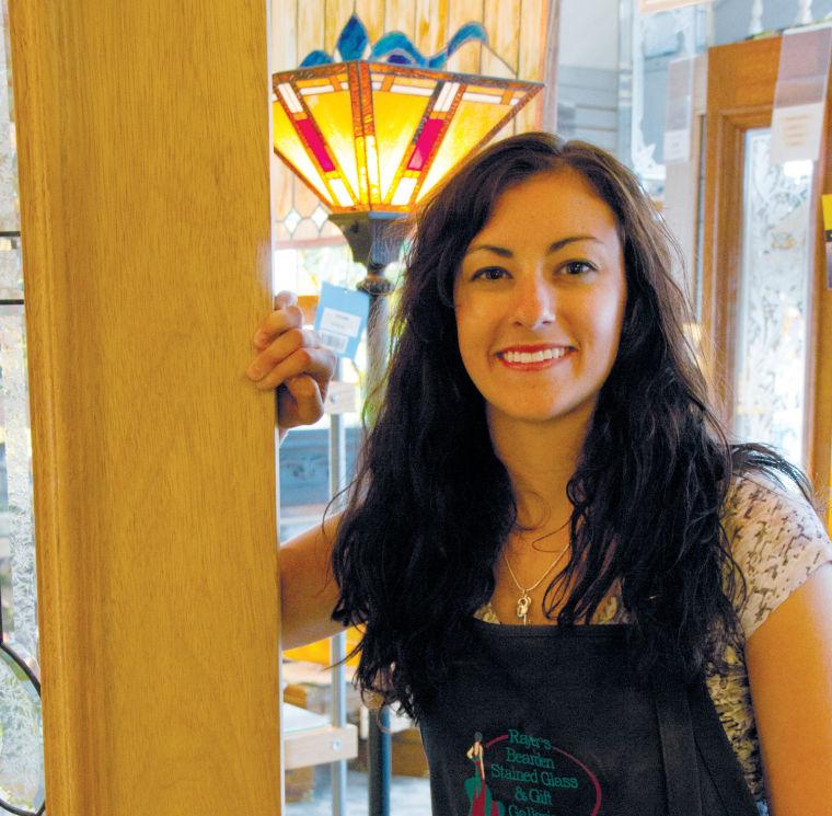 April Rayer stands in her family’s stained glass shop, Rayer’s Bearden Stained Glass Supply.