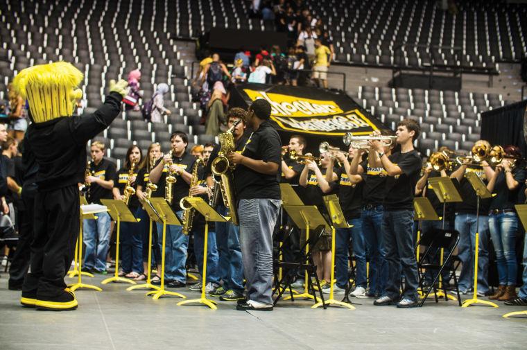 Wu-Shock+commanding+the+WSU+band+during+Convocation+2013+inside+Koch+Arena.