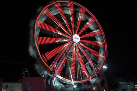 A ferris wheel spins around at the Kansas State Fair. This is the 100th year of the fair, held annually in Hutchinson, Kan.