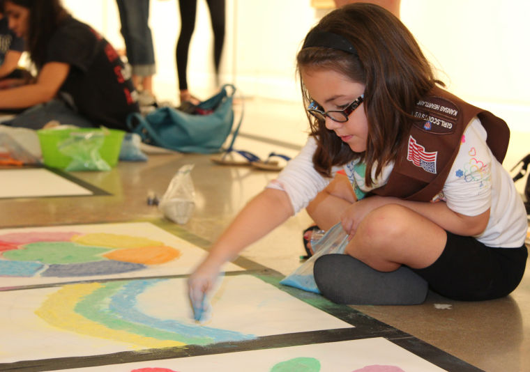 Those who created art weren’t solely of Indian descent. A group of 7-year-old Girl Scouts were “just trying to figure,” said Brenda Lichman, the troop leader. One of the Scout Girls drawing the Rangoli enthusiastically.