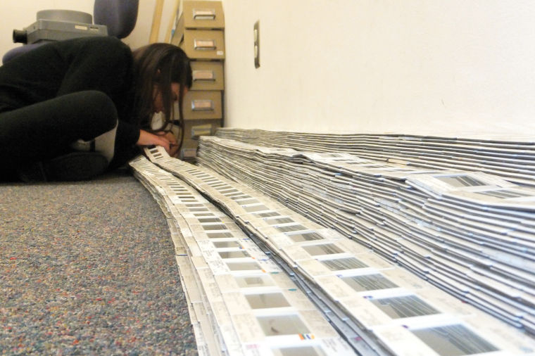 A participant organizes slides for the “Art Through the Ages” exhibit, which will be featured in McKnight through December.