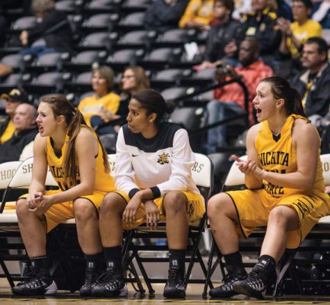 Moriah Dapprich (Left) and Michaela Dapprich (Right) cheer on the rest of their teammates during the WSU Vs. Southwest Baptist exhibition game on Sunday November 3rd at Koch Arena.