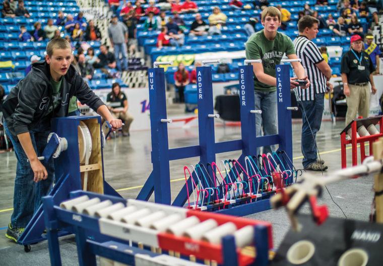 Two+particpants+attempt+to+place+an+item+into+the+objective+using+the+robot+they+created+at+the+15th+annual+Kansas+Robot+event.+The+event+was+sponsored+by+the+College+of+Engineering+and+middle+schoolers+from+all+over+Kansas+came+to+participate.+The+event+was+held+at+the+Hartman+Arena+on+Saturday+from+9%3A30am-4pm.