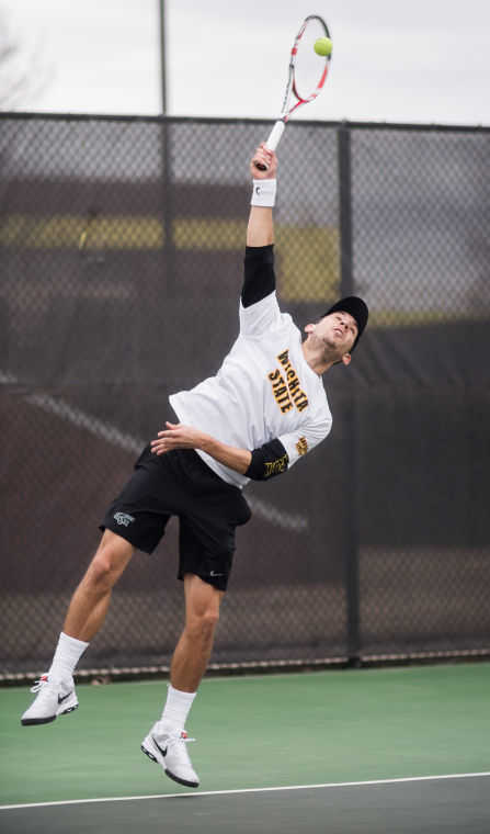 Senior Guillermo Nicol serves the ball back to his Cowley opponent Wednesday afternoon at the Sheldon Coleman Tennis Complex. Nicol won his singles match 6-0, 6-4, and the Shockers won overall 7-0.