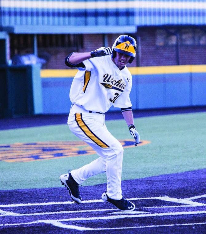 Freshman+Wes+Philips+slides+into+home+on+a+throwing+error+by+Justin+Treece+in+the+third+inning+of+Tuesdays+game+against+Central+Arkansas.+The+Shockers+beat+the+Bears+6-9+in+the+matchup.
