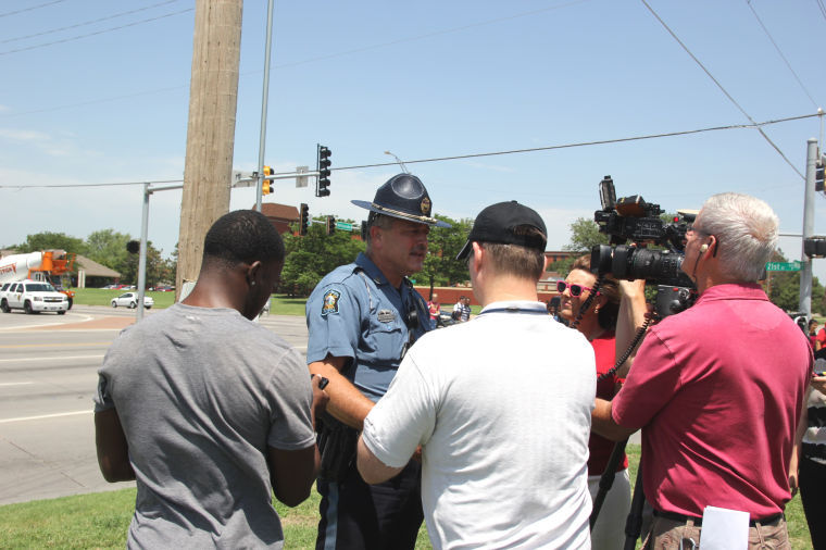 Gary Warner, Kansas Highway Patrol, speaks to the media about the apprehension of four murder suspects from California at the Bank of America at 21st and Hillside, across the street from the Wichita State campus. Warner said nobody in the immediate area was ever in any danger. The murders took place in Windsor, Calif., on June 22.