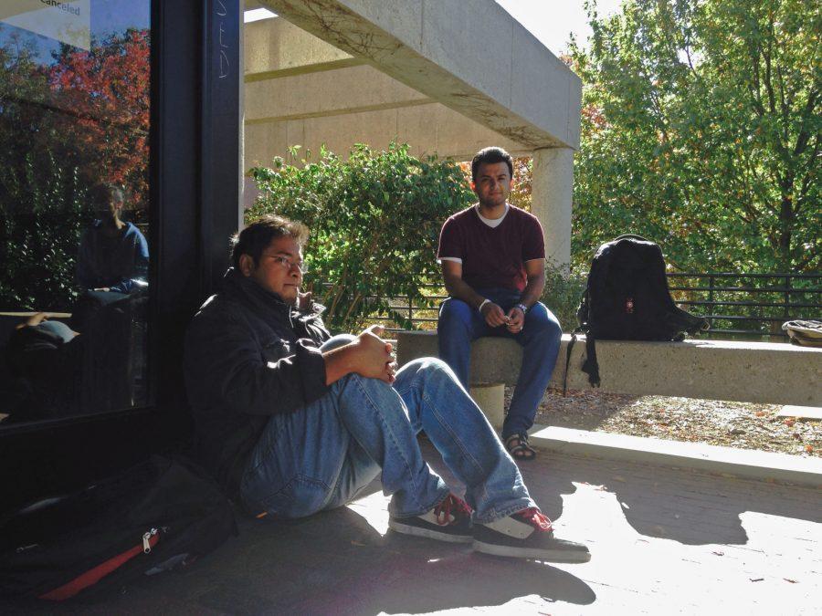 Waleed Alobaidi (right) waits with friends for the Ablah library to reopen after a power outage. The library reopened at 2 p.m. Thursday.