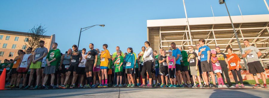 Runners at the 2014 WSU Campus Recreation Pumpkin Run line up at the starting line and wait while the national anthem is sung on Saturday morning.
