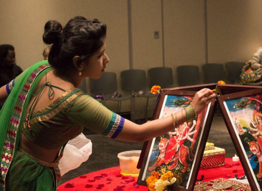 Wichita State student Anusha Powaku offers prayers to the Hindu Goddess, Durga, Mata at Garba Night Saturday. The festival was hosted by the Association of Hindu Students in America, a student organization that strives to increase understanding of Hinduism in the community.