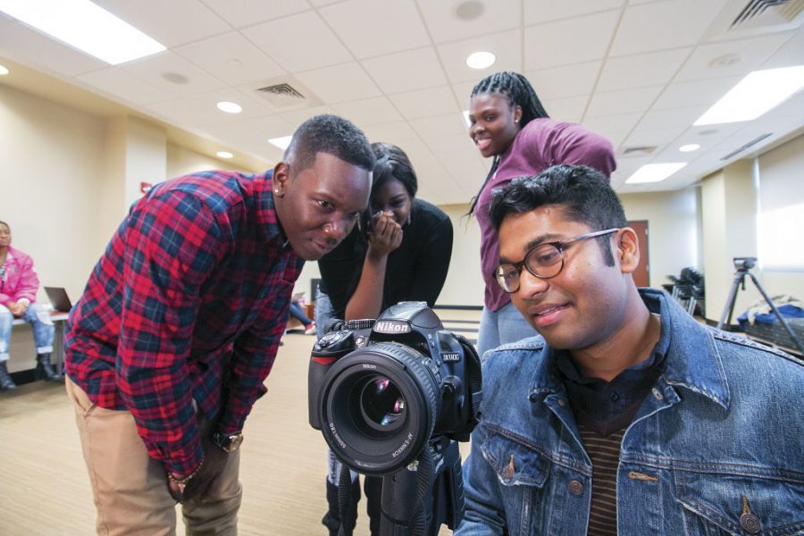 Students look at video footage from interviews done at the “Why My Life Matters” video shoot Tuesday. The video will be published on Facebook on Friday.