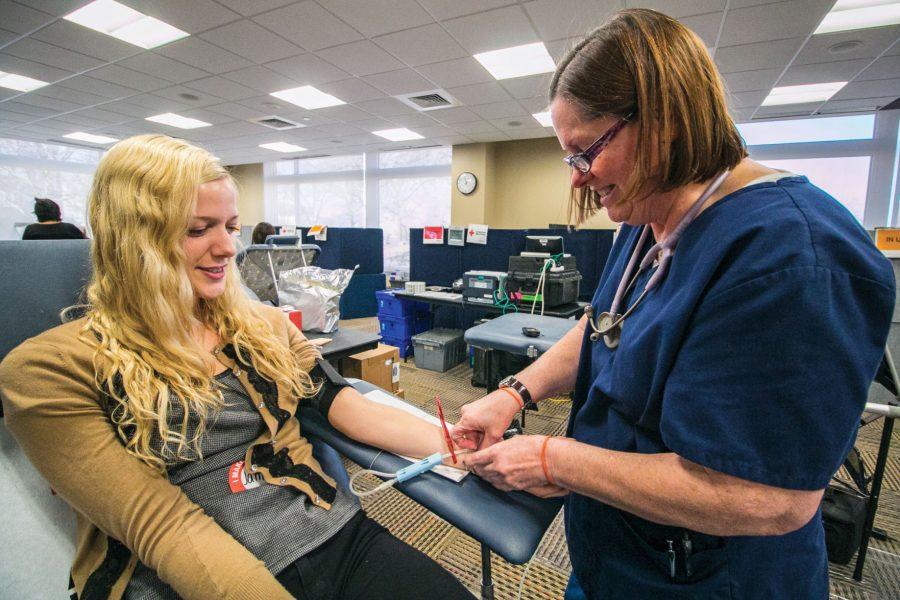 American Red Cross collections technician Debi Goodner prepares Wichita State graduate student Jamie Stephens’s arm for a blood donation at the American Red Cross blood drive Tuesday.