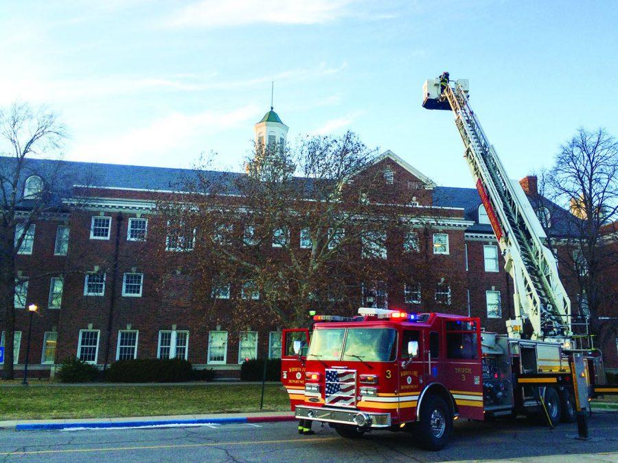 A fireman on a cherry picker surveys the fourth floor of McKinley Hall following a reported fire alarm on Monday. Fire crews later determined that the alarm was triggered by a steaming autoclave, a machine used to sterilize and clean lab equipment. The same autoclave triggered a fire alarm Tuesday afternoon.