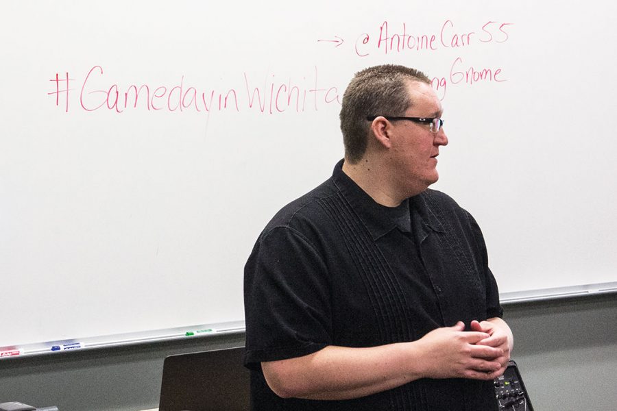 Mike Ross, Sport Public Relations class instructor, lectures students Monday. The class launched a social media campaign last year pushing for ESPN to host its College GameDay at Charles Koch Arena.