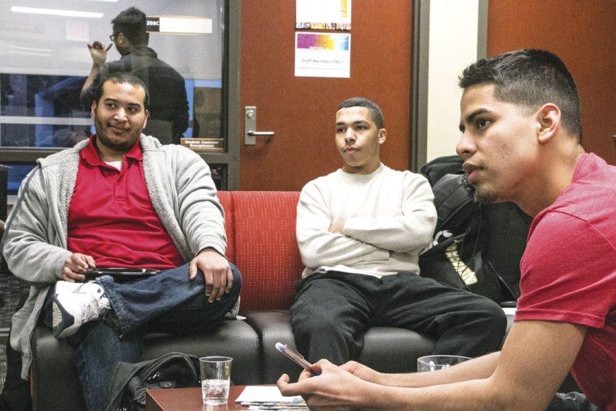 Men of Excellence members Devante Garcia, Josh Radford and Alberto Sosa talk with other members last week at the Office of Diversity and Inclusion.