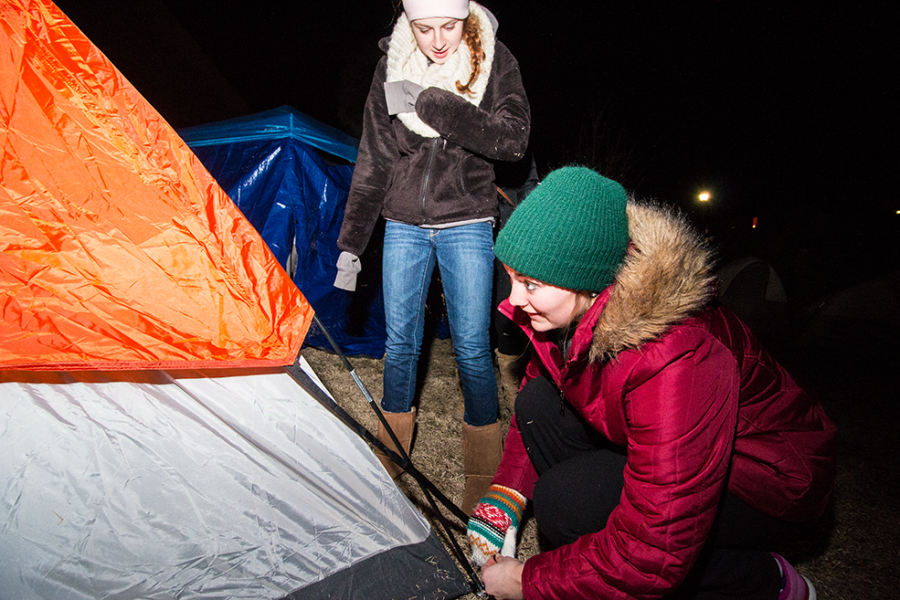 Junior Ashley Krier puts up a tent at Marshallville on Thursday night. Students braved temperatures below freezing to camp out and support the Shockers before taking on UNI Saturday afternoon.