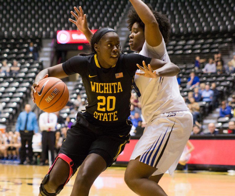 Brittany Martin (20) dribbles around Audrey Faber Sunday afternoon in Koch Arena. Wichita State beat Creighton 62-54.