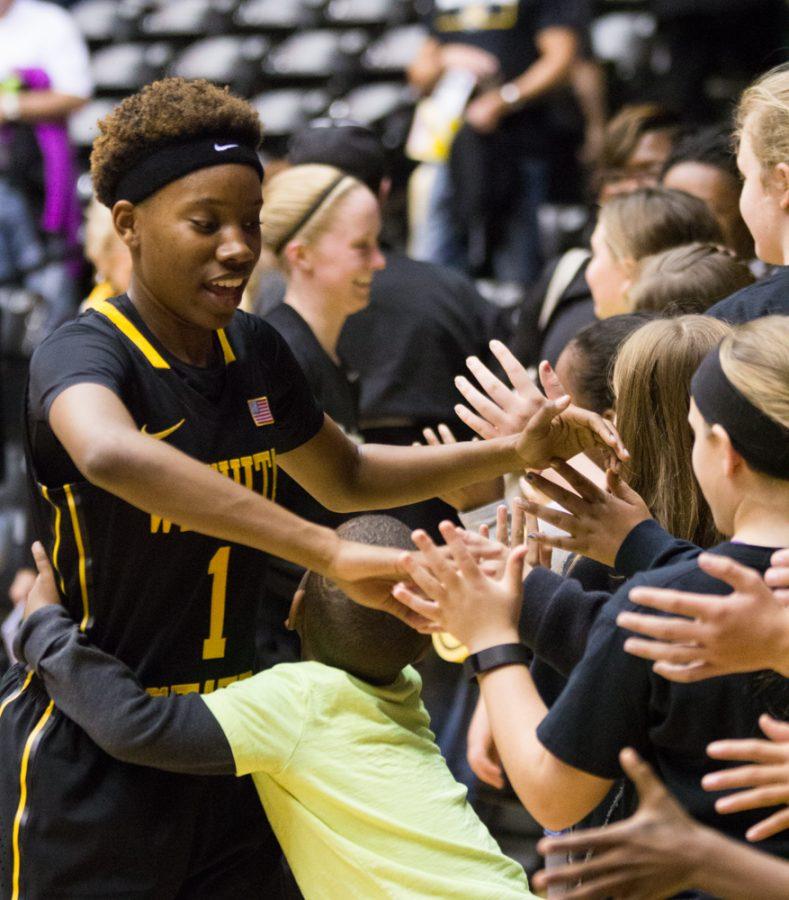 Keke+Thompson+high-fives+fans+and+even+gets+a+hug+after+Wichita+State%E2%80%99s+win+Sunday+afternoon.+Thompson+scored+11+points+against+Creighton.
