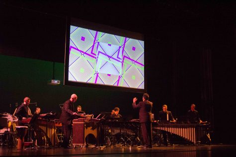 Gerald Scholl directs the Impulse Percussion Group Sunday evening as they perform “Palace of Nine Perfections” by Eric Ewazen. Laura Scholl’s Performative Drawings play on a screen in the background. The drawings are reactionary to what the musicians play.