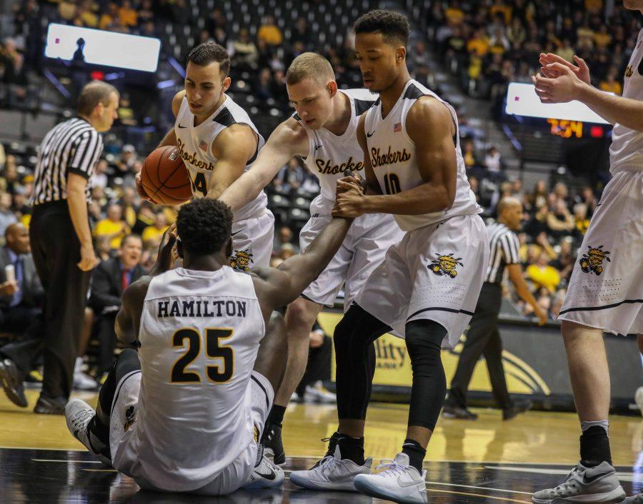 Teammates help Wichita State’s Eric Hamilton (25) to his feet after he tangled with an Illinois State player.