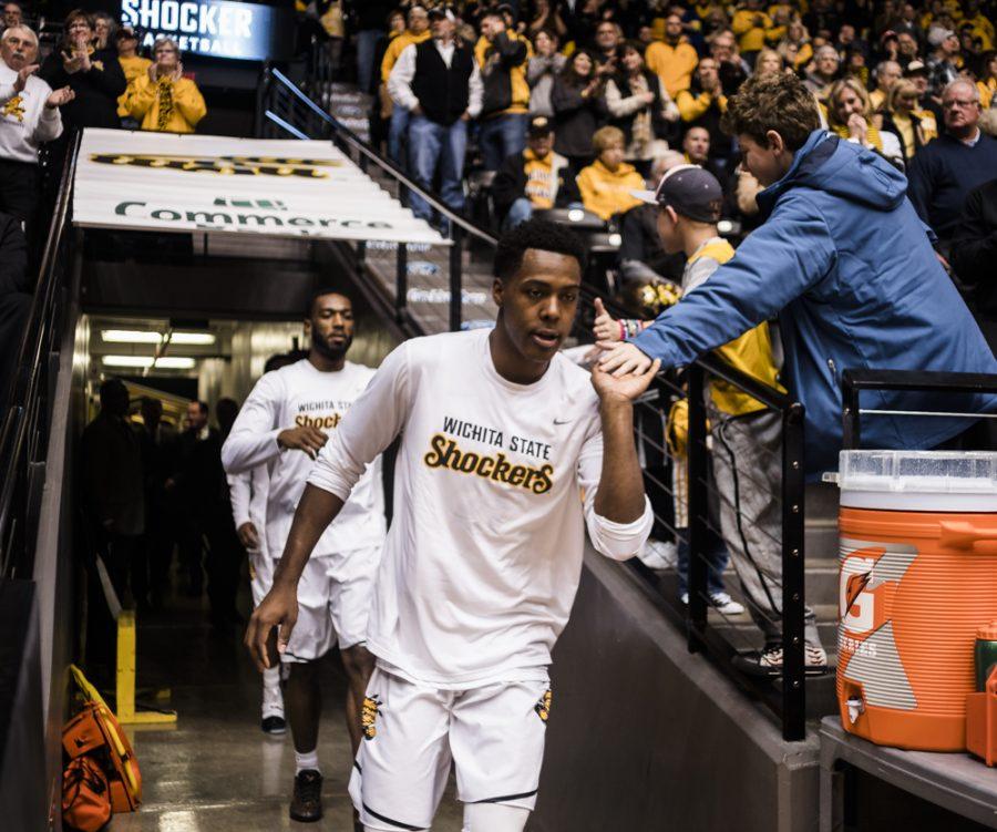 Junior forward Darral Willis, Jr (21) high fives fans prior to the game against Drake Wednesday night at Charles Koch Arena. (Jan. 4, 2017)