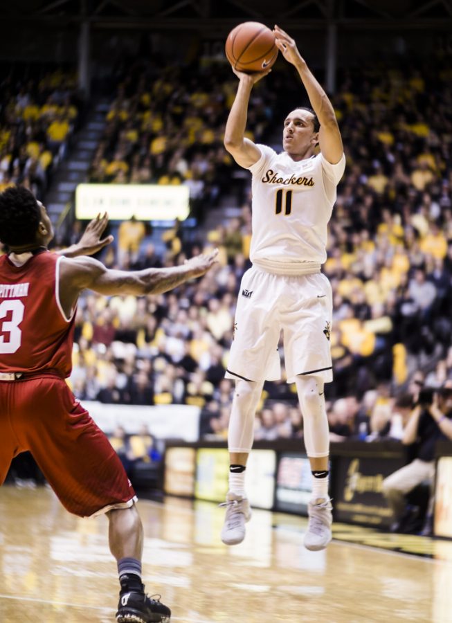 Freshman guard Landry Shamet (11) attempts a jumper over a Bradley defender in the first half Sunday afternoon at Charles Koch Arena. The Shockers went on to pummel the Braves 100-66.