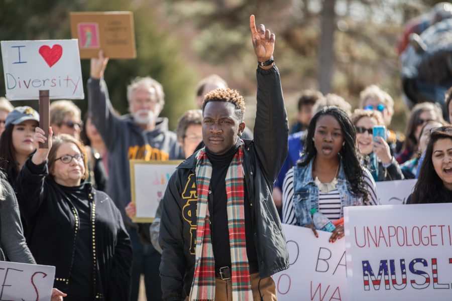Student body president Joseph Shepard holds up his hand while exciting the crowd at the “No Ban, No Wall” peace rally. The Rally took place outside of the Rhatigan Student Center on Tuesday afternoon and was to show solidarity to those who feel marginalized by President Trump’s rhetoric. (Jan. 31, 2017)