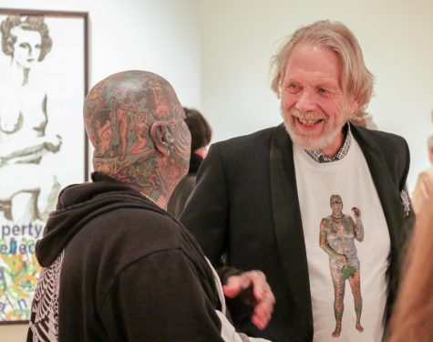 Professor Larry Schwarm talks to his subject Larry K. during opening night at the Ulrich Museum of Art on Saturday.