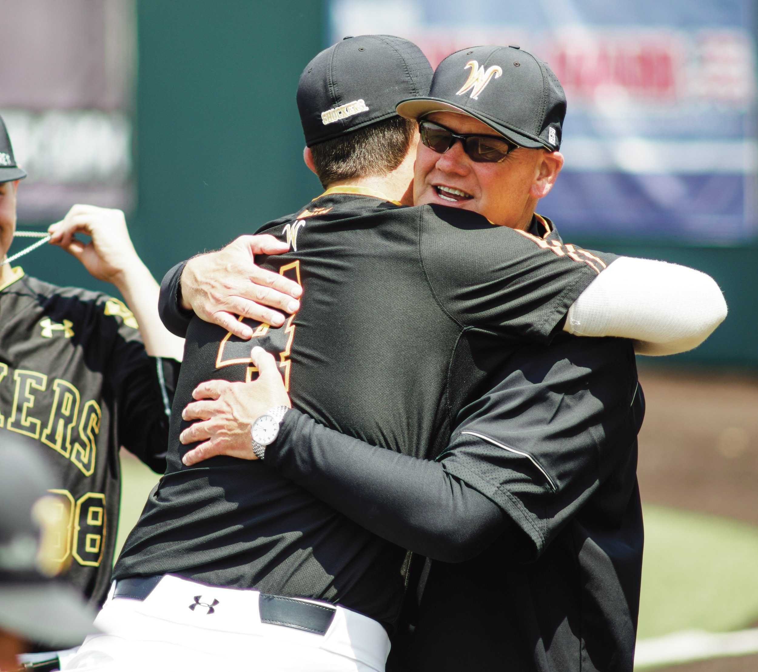Assistant Coach Brent Kemnitz hugs pitcher Cale Elam in the bullpen Saturday afternoon at Eck Stadium.(May 21st, 2016)