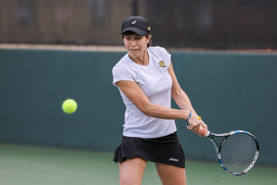 Wichita State Junior Guilia Guidetti takes a backhand swing in a singles match Friday against Kansas. The Shockers lost to the Jayhawks 2-5, ending Wichita State’s 34-match home win streak. (Feb. 17, 2017)
