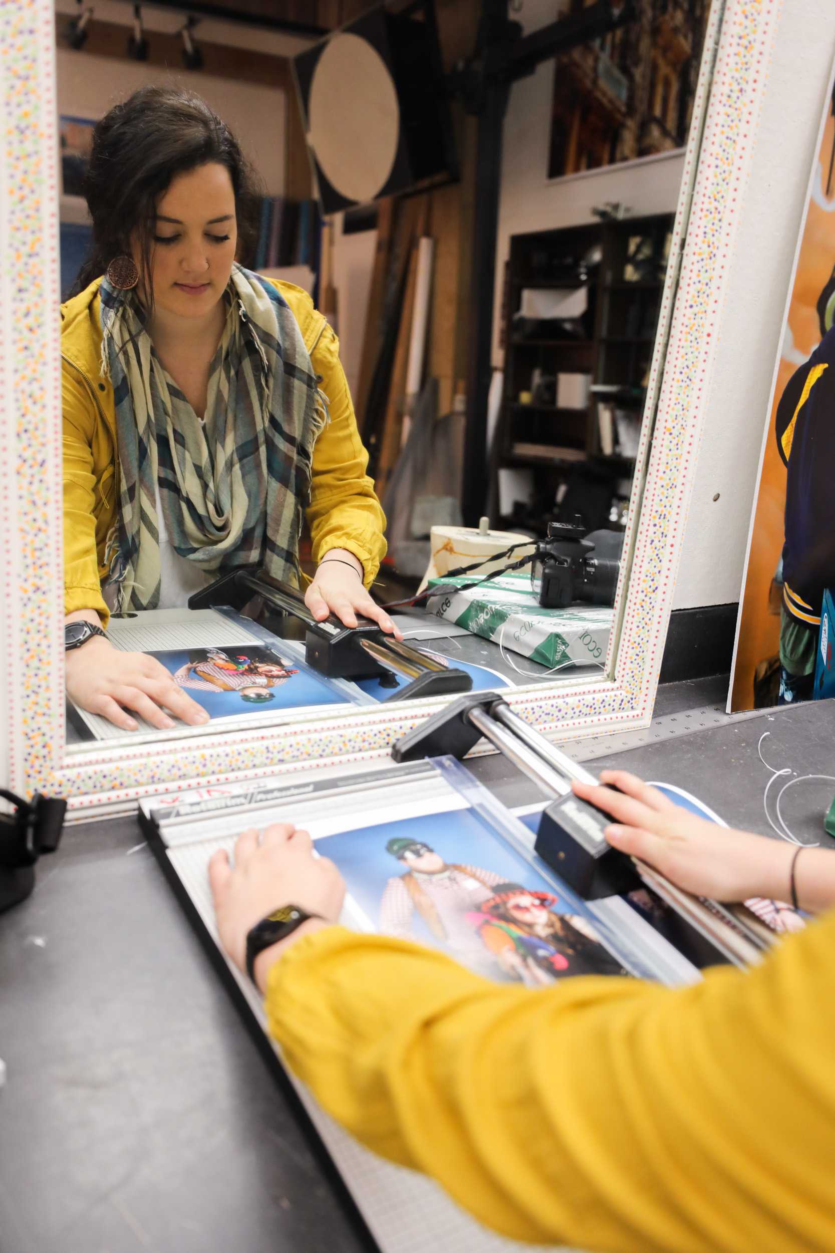 Mariah Drussel, Wichita State senior, cuts a print of a photo during the funky photo shoot in McKnight Art Center. The photo shoot was part of the ADCI open house held on Saturday. (Feb. 18, 2017)