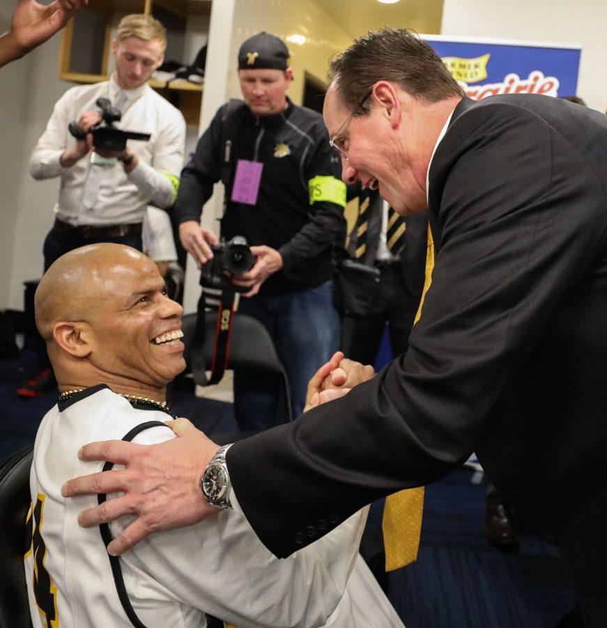 Gregg Marshall greets Darren Thomas, a die-hard Shockers fan, in the locker room after the championship game in St. Louis.