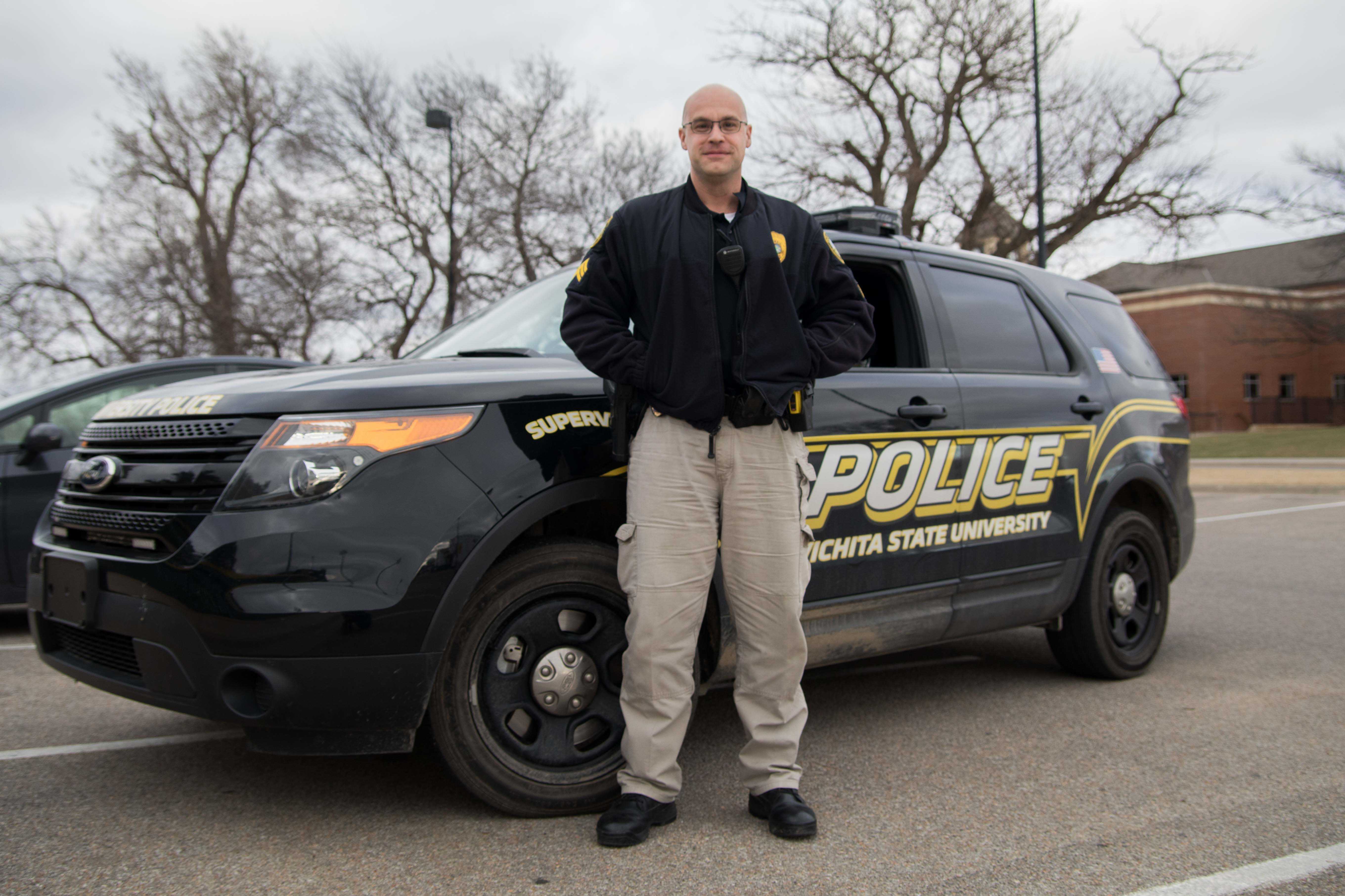 Administrative sergeant Garrett Moyer stands outside of Eck Stadium on Friday afternoon. Moyer has to balance his career at the Wichita State Police Department with going to graduate school.