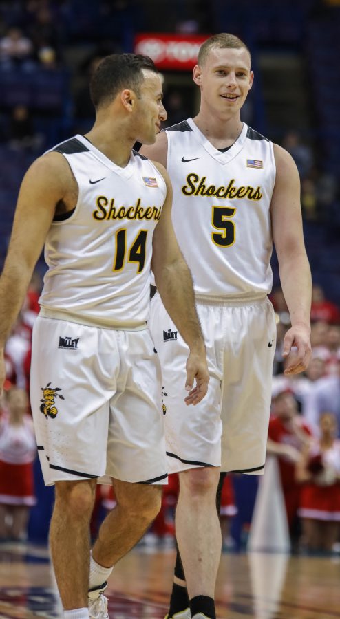 Wichita State seniors John Robert Simon (14) and Zach Bush (5) talk at half court during the first free throw shot. Simon and Bush are the only two seniors on the Wichita State team.