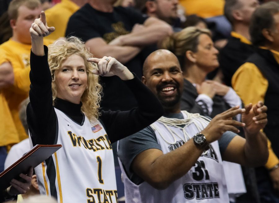 Head coach Gregg Marshalls wife Lynn points to the cheerleaders and pep  band during a cheer after the Shockers 82-56 victory over Bradley.
