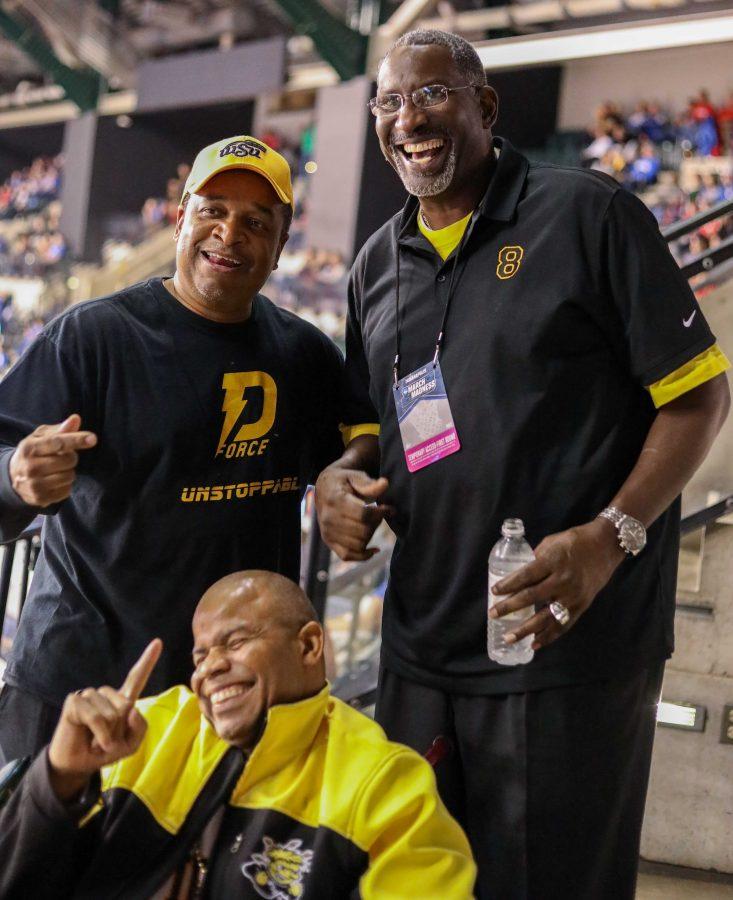Wichita State fans Darren Thomas (bottom) and William Polite (left) take a photo with Wichita State and NBA player Cliff Levingston in Bankers Life Fieldhouse on March 17, 2017.