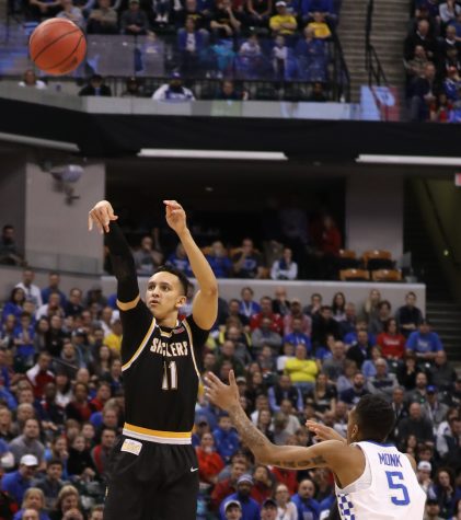 Wichita State guard Landry Shamet shoots a three pointer over Kentucky guard Malik Monk in the first half of the second round of the NCAA Tournament in Indianapolis. (Mar. 19, 2017)