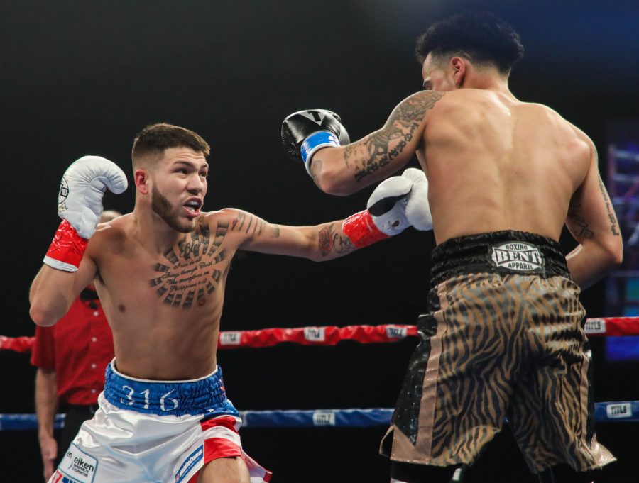 Nico Hernandez throws a left hook against Pat Gutierrez during the first round at Kansas Star Arena in Mulvane.  (Mar. 25, 2017)
