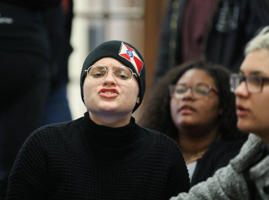 Sandra Carlo, freshman, conducts chants at the sit in outside of university president John Bardo’s office on Tuesday afternoon. The group chanted demanding to know what happened to Eric Maki as well as for transparency among the administration. (Mar. 14, 2017)