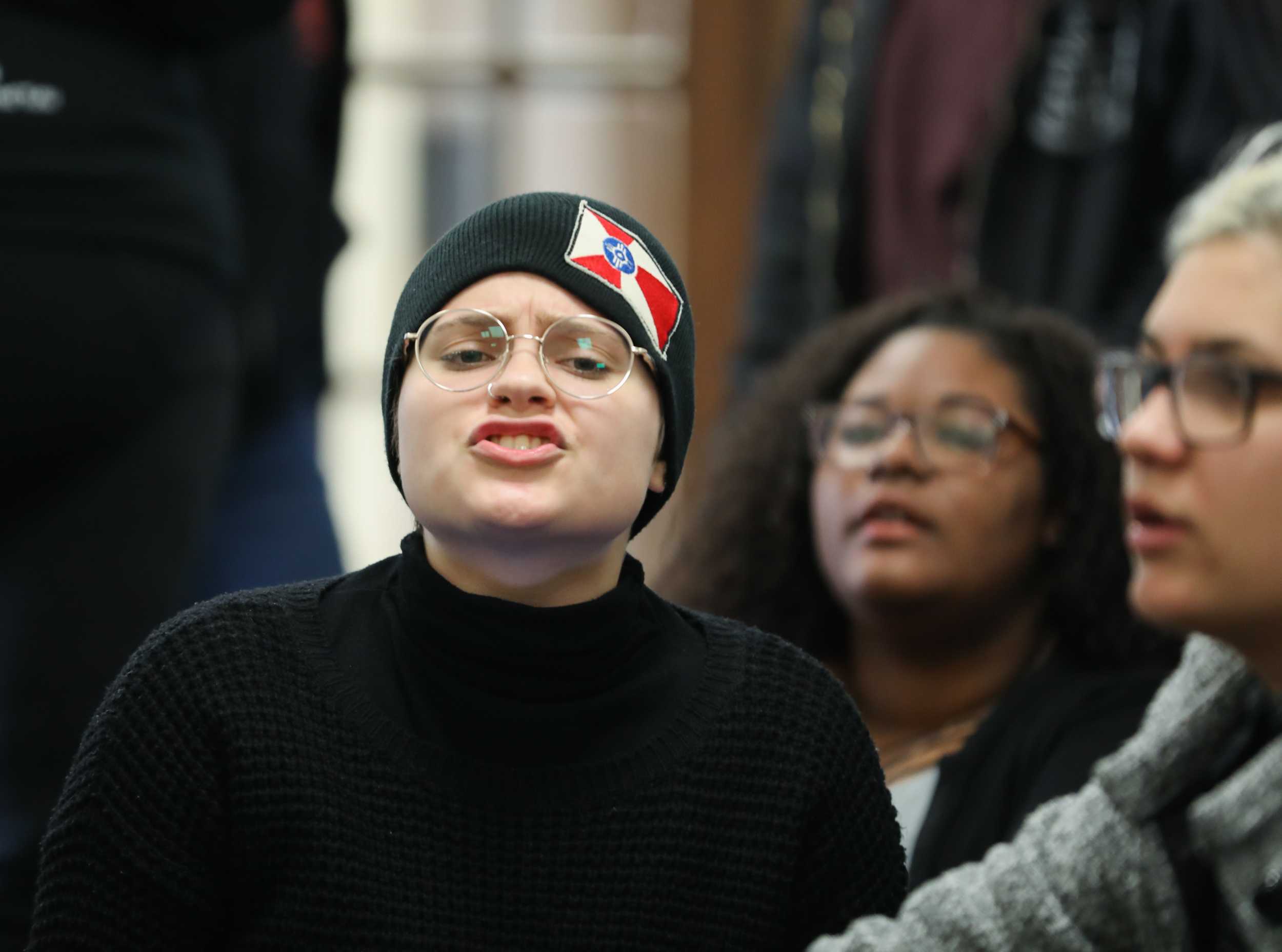 Sandra Carlo, freshman, conducts chants at the sit in outside of university president John Bardo’s office on Tuesday afternoon. The group chanted demanding to know what happened to Eric Maki as well as for transparency among the administration. (Mar. 14, 2017)